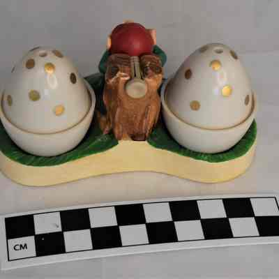 Back and size comparison of elf salt and pepper shaker set.