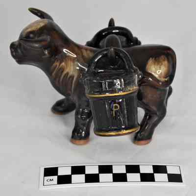 Other side and size comparison of ox salt and pepper shaker set.