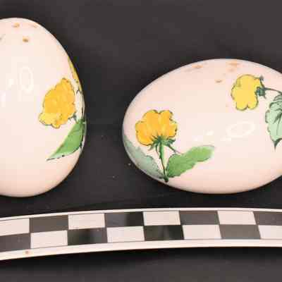 Other side and size comparison of egg salt and pepper shakers.