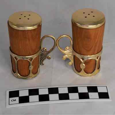 Back and size comparison of wooden salt and pepper shakers.