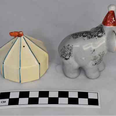 Back and size comparison of circus tent and elephant shakers.
