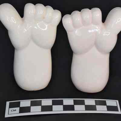 Back and size comparison of feet salt and pepper shakers.