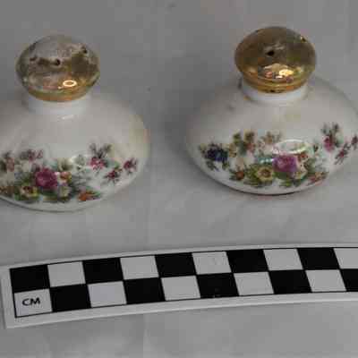 Size comparison for floral salt and pepper shakers.