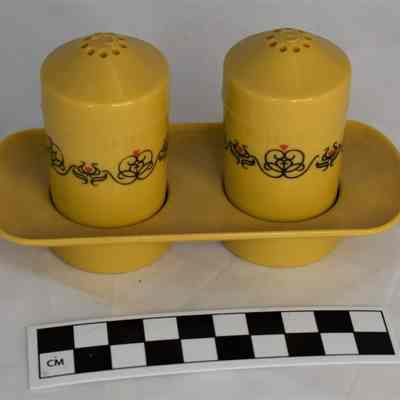 Other side and size comparison of harvest gold salt and pepper shaker set.