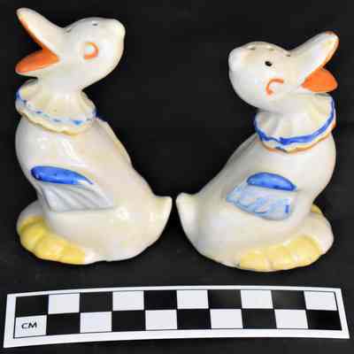 Other side and size comparison of duck salt and pepper shakers.