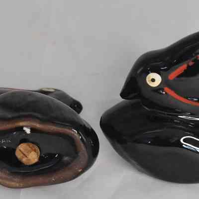 Bottom and side of black pelican salt and pepper shakers.