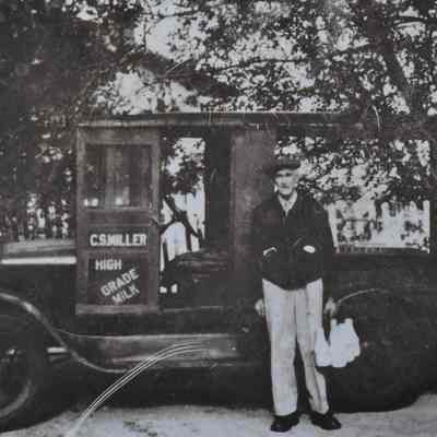 Claude Miller in front of the milk truck in the 1940s or 1950s.