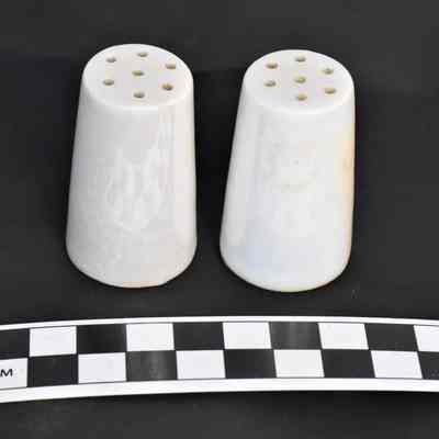 Other side and size comparison of white luster shakers.