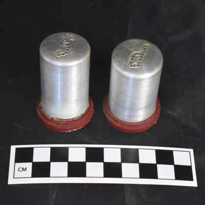 Back and size comparison of the aluminum salt and pepper shakers.