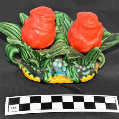 Other side and size comparison of rose bud salt and pepper shakers set.
