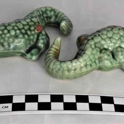 Other side and size comparison of alligator salt and pepper shakers.