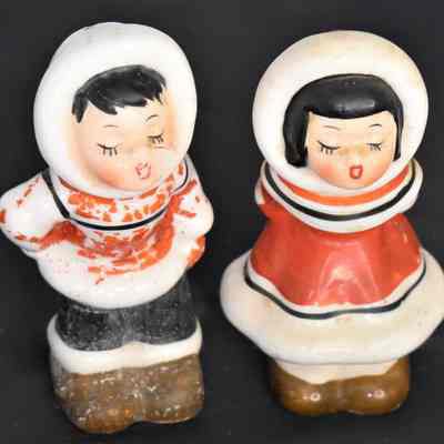 Fronts of Eskimo salt and pepper shakers.