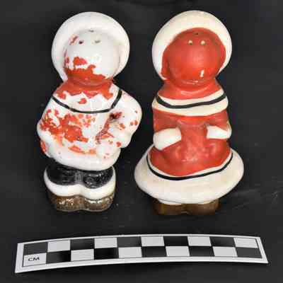 Back and size comparison of Eskimo salt and pepper shakers.