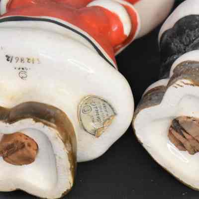 Numbered on the bottom of each shaker. Girl Eskimo has original National Potteries label.
