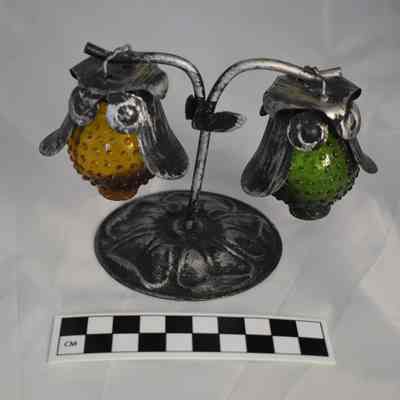 Back and size comparison of the owl salt and pepper shakers with a metal stand.