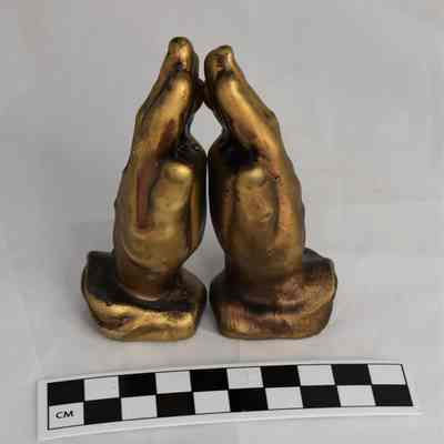 Other side and size comparison of praying hands salt and pepper shakers.
