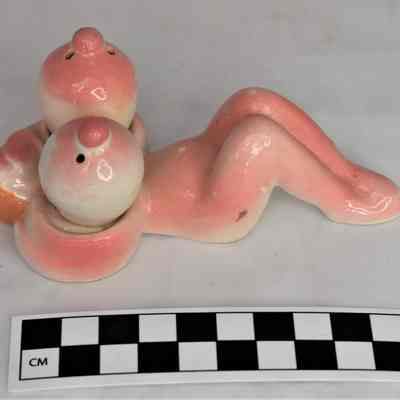 Size comparison of nude salt and pepper shaker set.
