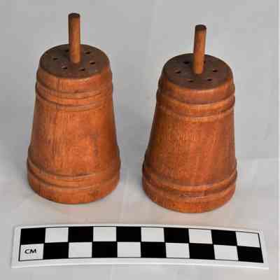 Other side and size comparison of butter churn salt and pepper shakers.