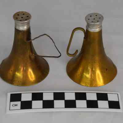 Flipped view and size comparison of the brass instrument salt and pepper shakers.