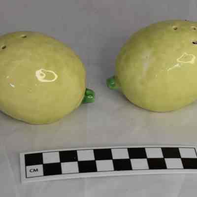Other side and size comparison of lemon salt and pepper shakers.