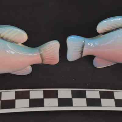 Other side and size comparison of fish salt and pepper shakers.