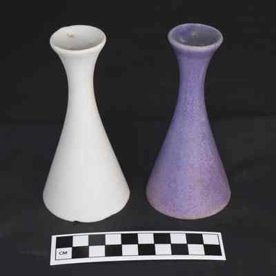 Flipped view and size comparison of the Andersen Design white and purple salt and pepper shakers.