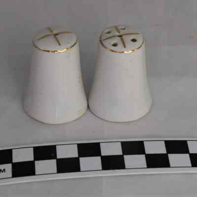 Back and size comparison of Hawaii salt and pepper shakers.