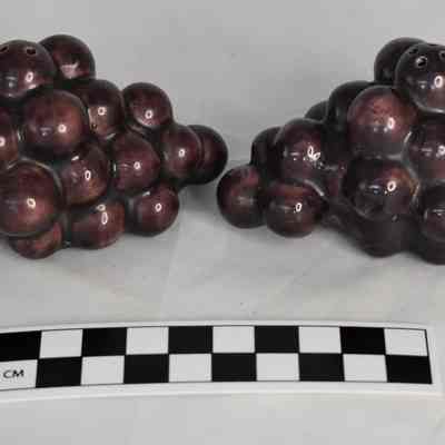 Other side and size comparison of grapes salt and pepper shakers.