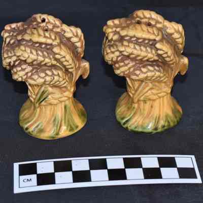 Back and size comparison of wheat salt and pepper shakers.