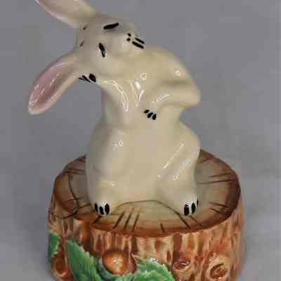 Rabbit shaker sitting on tree stump shaker.