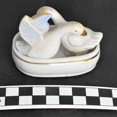 Other side and size comparison of birds with basin salt and pepper set.
