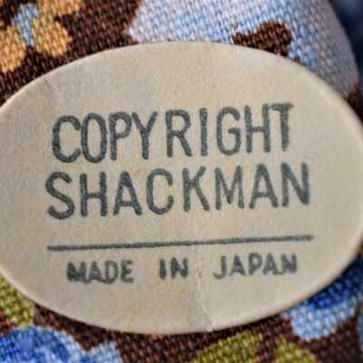 Shackman Sticker: Located on the back of her dress