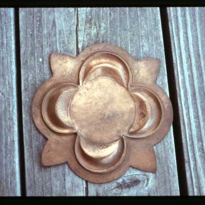 Brass medallion on the Coates' porch in 1994.  Image taken by Lisa Taft.