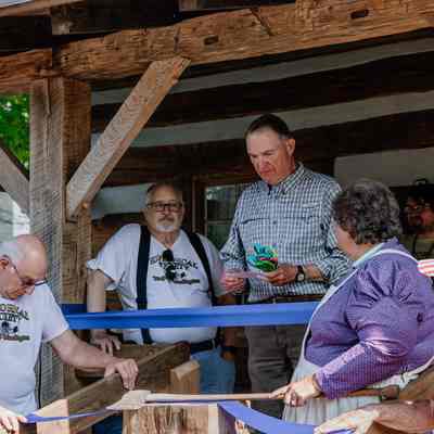 Phil Barker giving a speech 1835 Barker Family Log Cabin front porch before ribbon cutting