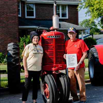 Steve Osborne with his Farmall Tractor and his wife Linda Osborne
