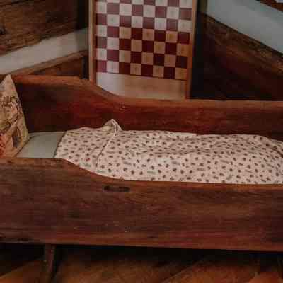Baby crib and checkers board in log cabin