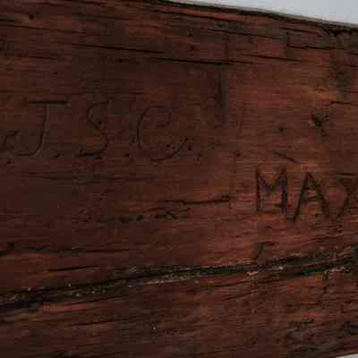 Markings on old wood beams of log cabin