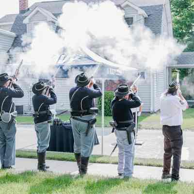 The Veterans of Foreign Wars and the American Legion detail and Civil War reenactors performing a gun salute