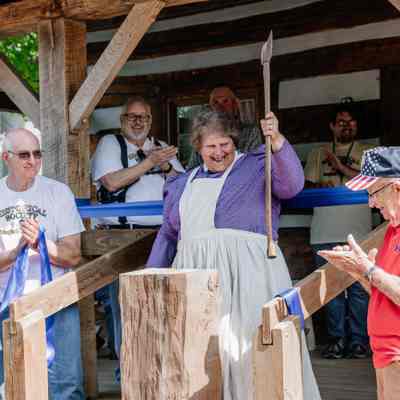 Diana Peyton chopped the ribbon for the Ribbon Cutting of the 1835 Barker Family Log Cabin