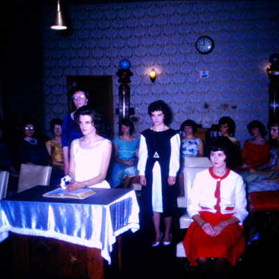 Young women inside during a ceremony.