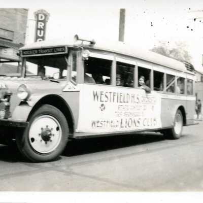 Westfield H.S. Orchestra shown on a Hoosier Transit Lines Bus in front of Mendenhall's Drug Store
