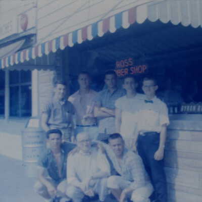 Doc Ross Barbershop 7 teenagers and one older man posing in front