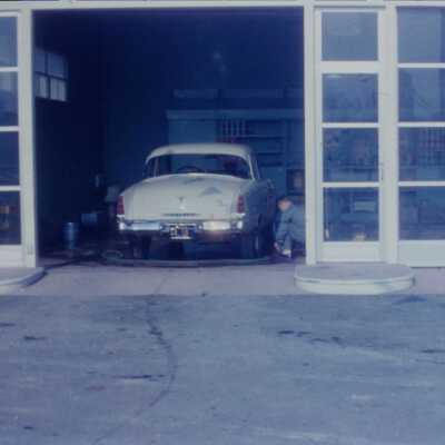 Cities Service Gas Station with car in bay, man working