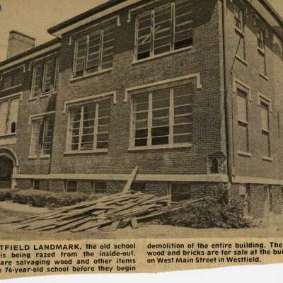 A newspaper clipping showing the old Westfield Middle School as it is prepared for destruction.