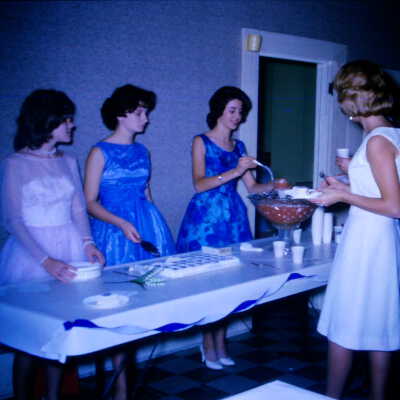 Young women giving out food inside