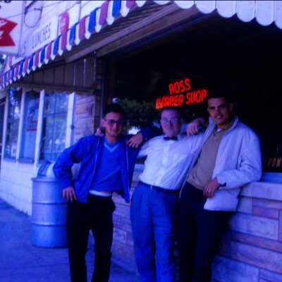 Doc Ross and two younger man in front of Ross Barber Shop