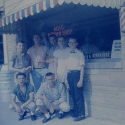 Doc Ross Barber shop with 7 teenage boys posing in front of store