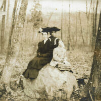 Marshall-Schmidt Photo Album: Margaret Marshall and two other females seated on a rock