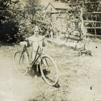 Marshall-Schmidt Album: Margaret Marshall with Bike in Backyard