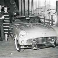          Jacqueline James and Warde Donovan Travel in a Thunderbird to the Dutch Country in Pennsylvania in Plain and Fancy, 1956.
   